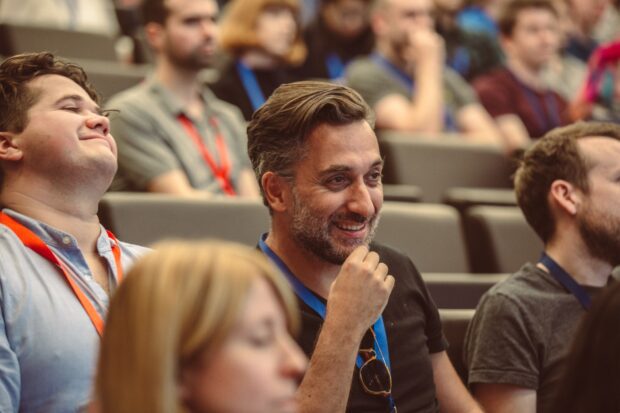 A photo of people in a audience at a conference