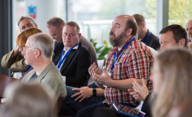 A photo of people discussing public services at an event