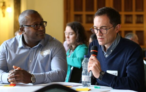 A photo of people discussiong public services at a conference