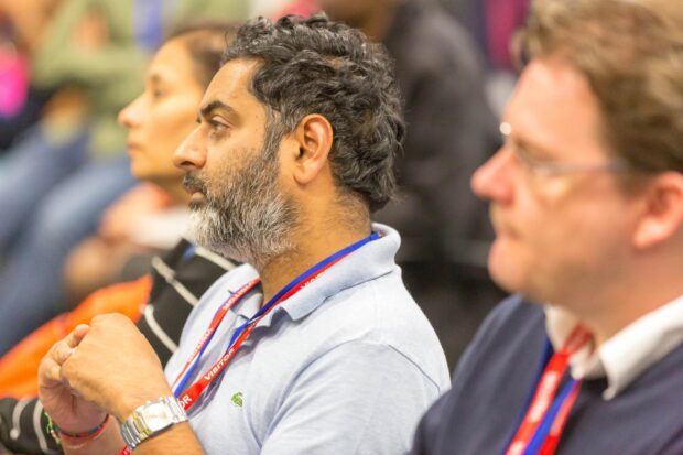 A photo of people in the audience at a conference