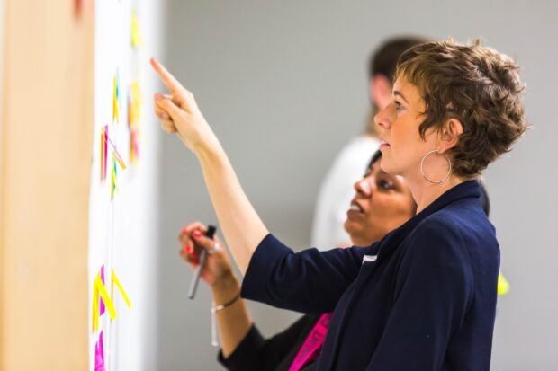 A photo of civil servants working together to analyse information.