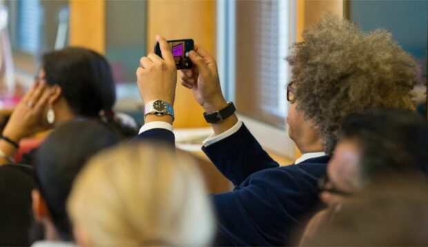 A photo of the audience at an event about making public services.