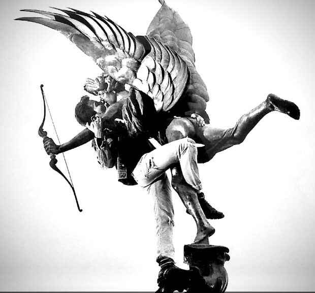 A photo of Richard Sandells kissing the Eros statue in Piccadilly Circus as part of a kiss-in protest against Section 28.