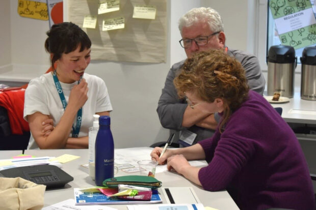 People participating in a workshop about the policymaking environment in HMRC.