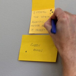 A sticky note that reads 'fuzzy ethos'