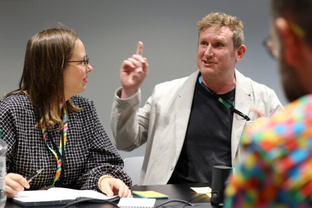 A photo of Anni Leppanen and Andrew Knight speaking at an event.