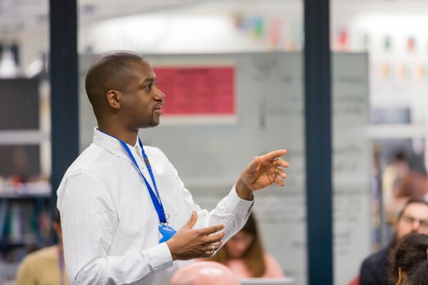 A photo of a person speaking in a workshop