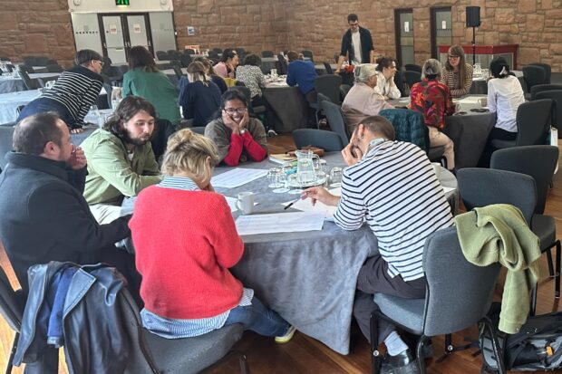 A photo of a group of people participating in an event about public services