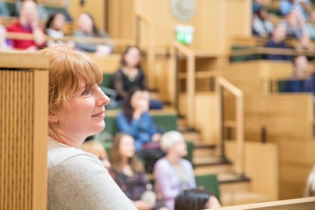 A person listening to a discussion about public services.