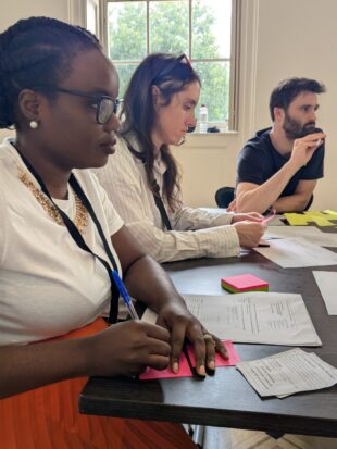 A photo of UK designers working with the public in their pavilion