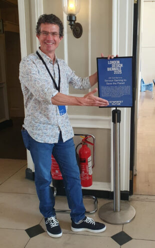 A photo of a UK designer welcoming the public to their pavilion