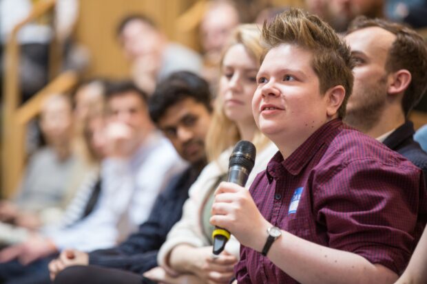 A photo of people participating in a conference.